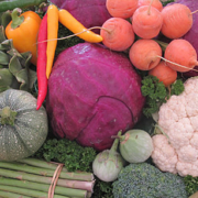 mixed produce including carrots, peppers, purple cabbage, cauliflower, and more