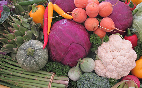 mixed produce including carrots, peppers, purple cabbage, cauliflower, and more